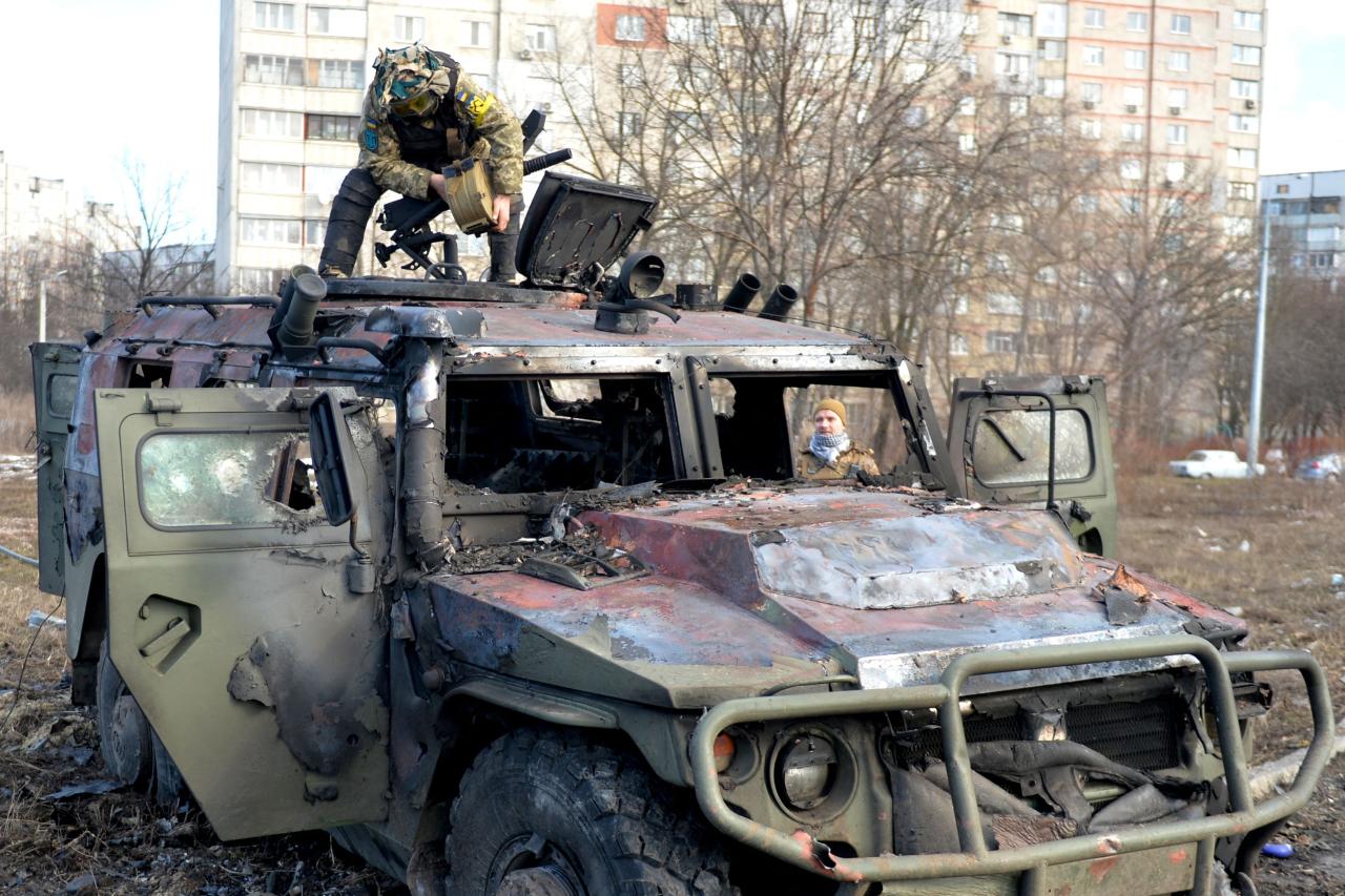 Soldados ucranianos durante una inspección de un vehículo militar ruso quemado en Kharkiv