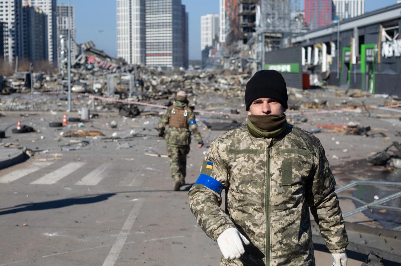 Soldados ucranianos vistos en el lugar de un ataque con cohetes en un centro comercial en Kiev