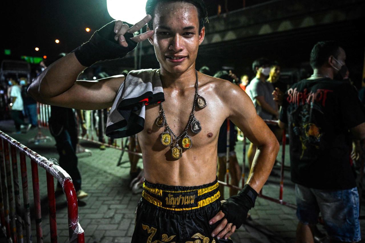 Un boxeador amateur de muay thai posa en una competencia no autorizada